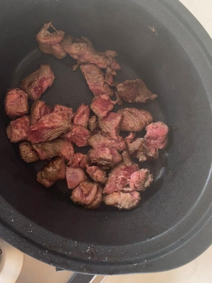Step 2 in the recipe for Slow Cooker Beef Stew.